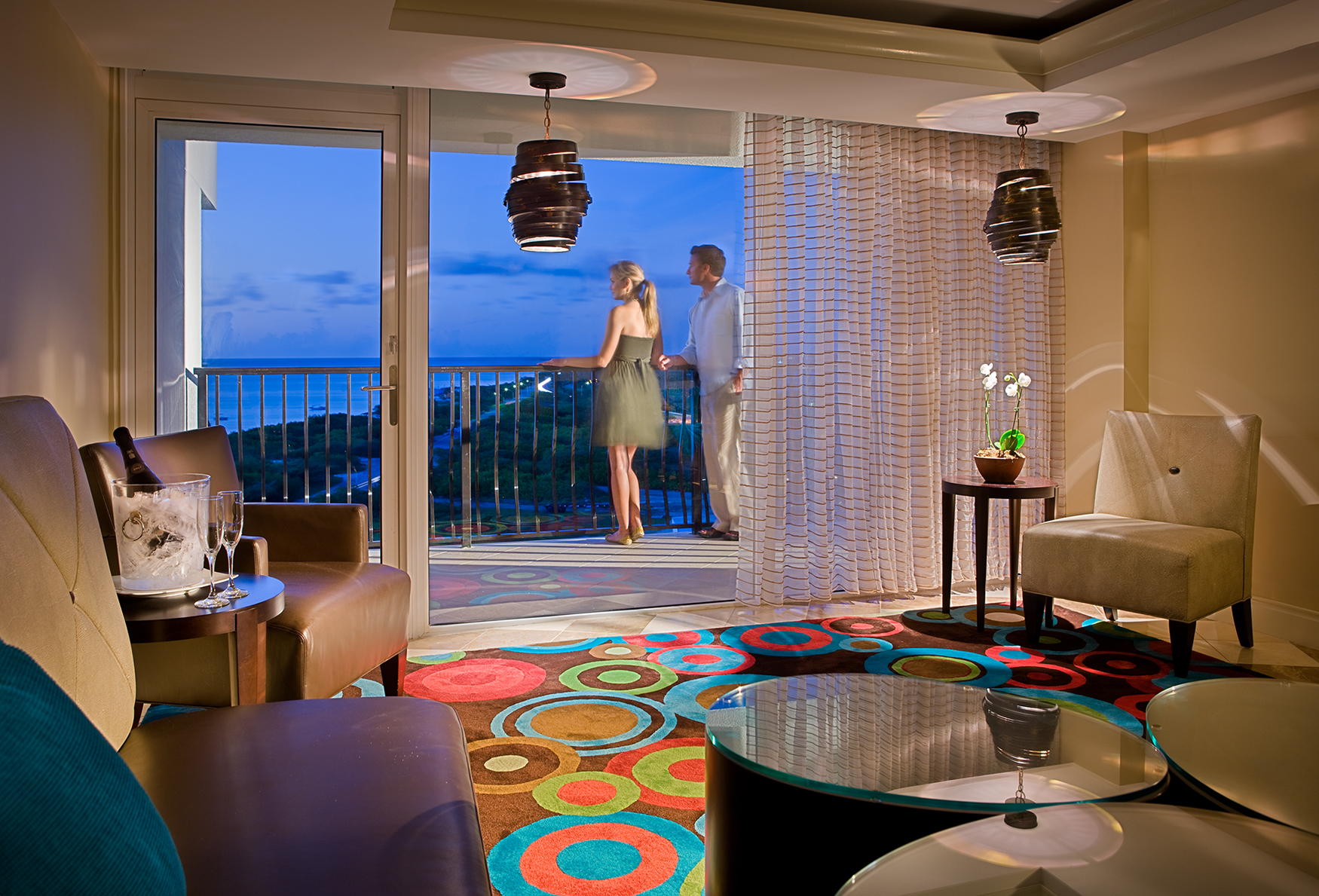 Resort room with couple on balcony. 